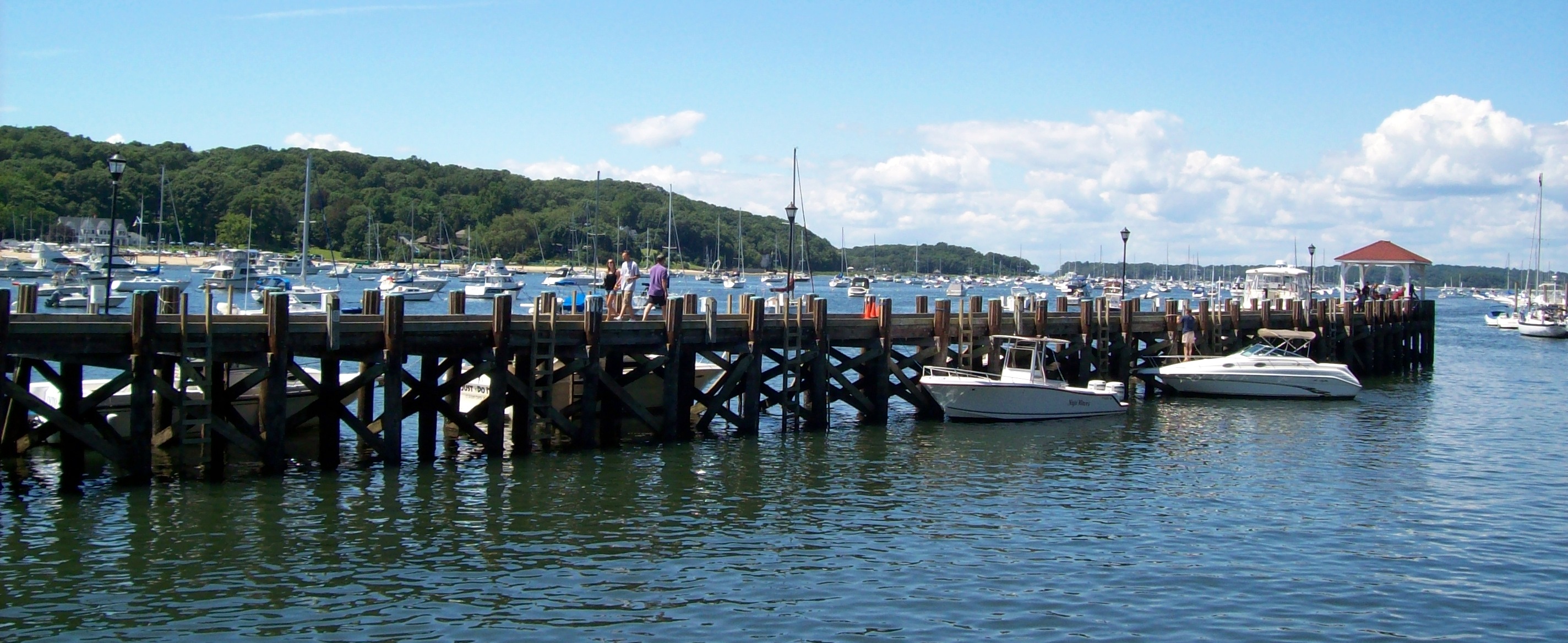 Northport Harbor dock with sailboats and motorboats on the water